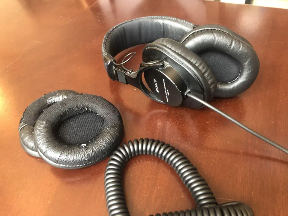 The headphones from the side, with the original pads in front.